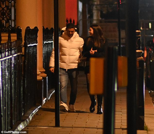 Cozy: She styled her ensemble with opaque fishnet tights with lace detailing and knee-high leather boots