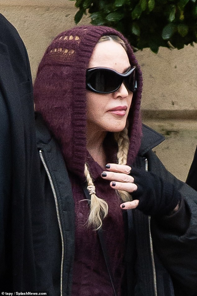 Outing: The singer kept warm with a pair of gloves and wrapped her phone strap around her neck as an accessory