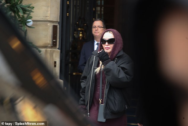 Casual: Madonna looked comfortable in her mauve ensemble, paired with a trendy bomber jacket