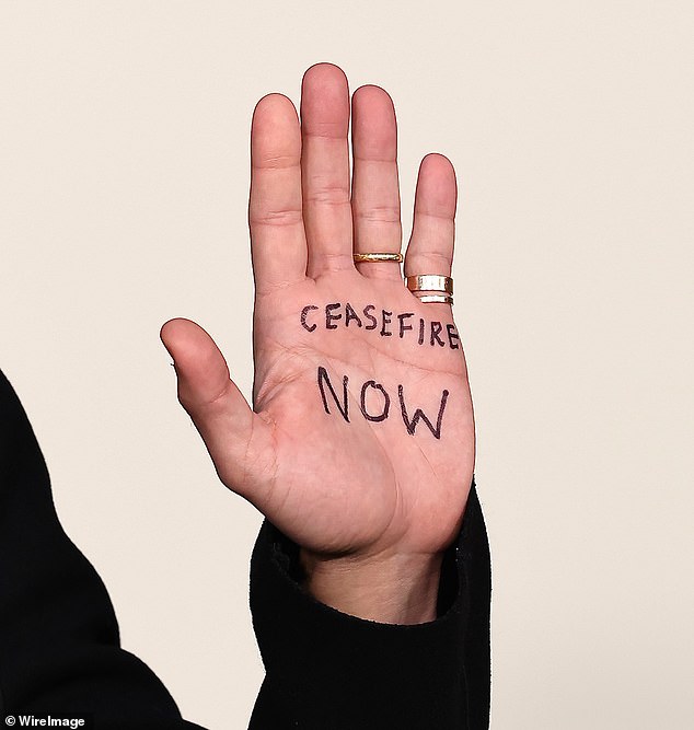 Clear message: The actor, 42, who plays Dodi Fayed in the Netflix show, wrote 'Ceasefire NOW' on his hand with black highlighter