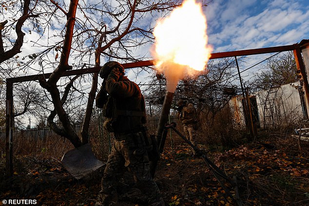 Members of the Ukrainian Omega Special Purpose Unit of the National Guard fire a mortar at Russian troops in the frontline city of Avdiivka