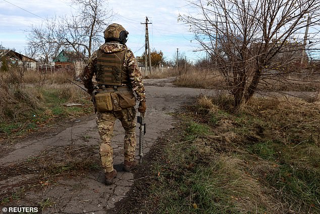 A member of the Ukrainian National Guard Omega Special Purpose walks to a position in the frontline city of Avdiivka, amid the Russian attack on Ukraine