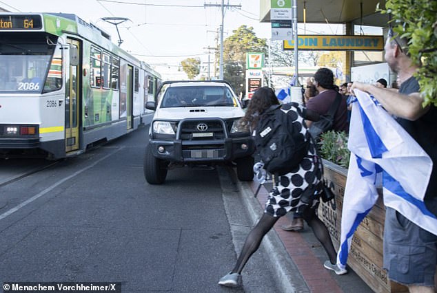 Shocking footage has captured the moment a Toyota HiLux ute apparently drove onto a footpath and narrowly missed Israeli supporters in Melbourne