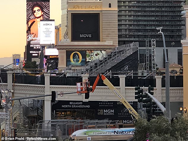 Cranes push together bleachers in front of the Bellagio fountains, depriving tourists of a view