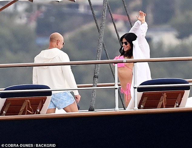 Bezos stares at Lauren as she stretches out in her pink bikini on his superyacht off the coast of Spain, also pictured in May