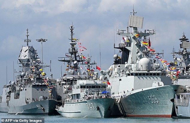 The Chinese Navy's missile frigate Yulin (R) and minesweeper fighter Chibi (C) are seen docked at Changi Naval Base during the IMDEX Asia warships exhibition in Singapore on May 4, 2023