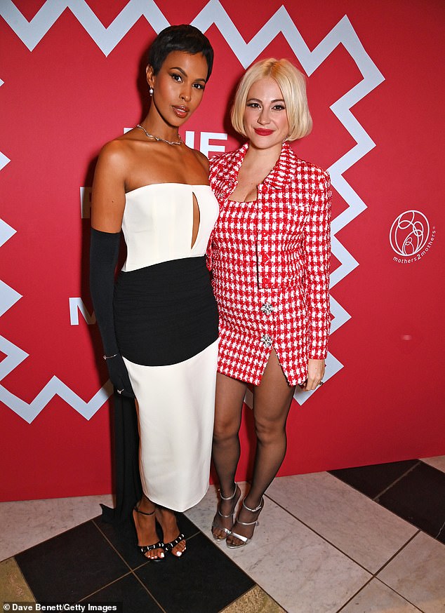 Flawless: She completed her trendy look with a classic bold red lip and a hint of shimmery eyeshadow, while wearing a sleek blonde bob (pictured with Sabrina Elba)