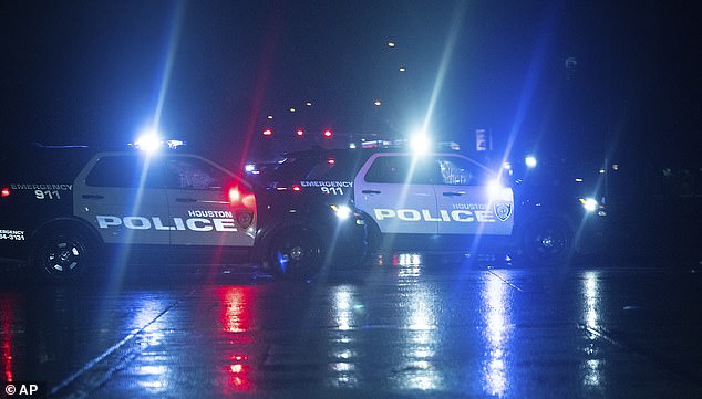 Houston police cars block access to Main Street near Sam Houston Parkway.  Negrete has not yet been found and police have warned he is considered armed and dangerous