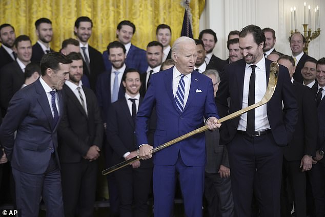 The Golden Knights presented President Biden with a custom gold home jersey and a hockey stick