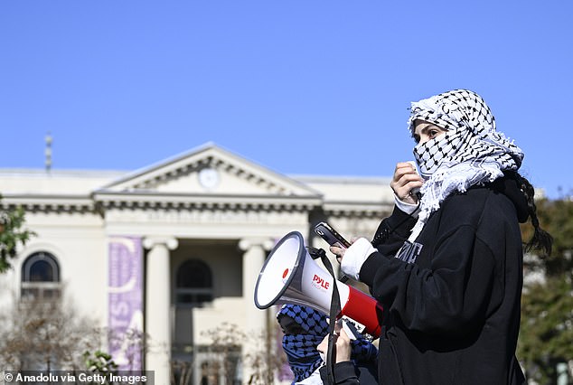 A protester holds a megaphone as American University students attend a campus protest against the ongoing Israeli attacks on Gaza in Washington, D.C.