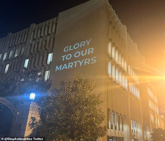 An image projected on the George Washington University library reads: 'Glory to our martyrs'