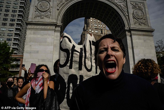 A woman shouts slogans as students from NYU (New York University) participate in a walkout during a national day of action called 'Students for Justice in Palestine' in Washington Square Park