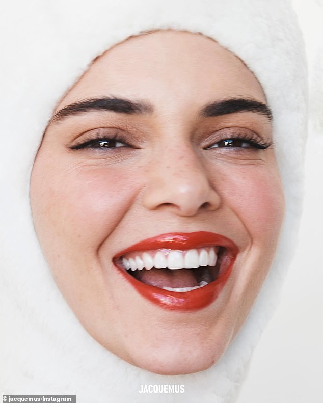 Cheeky: Kendall also shared an extreme close-up and smiley photo of her lightly made-up face bundled up in a white balaclava