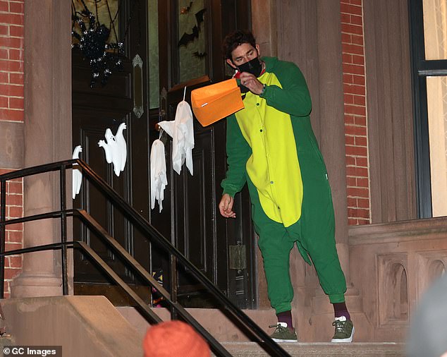 Hilarious: John looked cozy in his dinosaur-themed pajamas