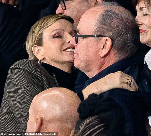 The royal was spotted cheering and hugging her Prince Albert as he congratulated her on her home country's victory against New Zealand at the Stade de France