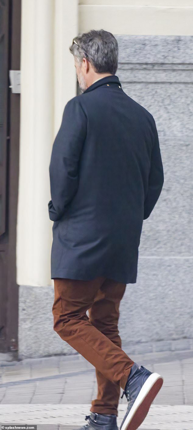 The Crown Prince is pictured entering the apartment complex to change after a walk in the park