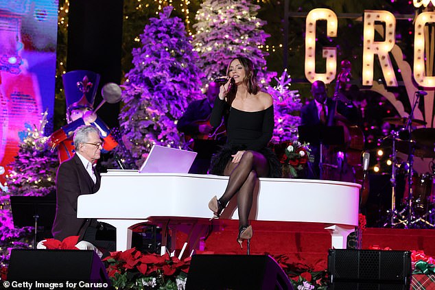 Spreading holiday cheer!  McPhee serenaded the audience while her husband served as pianist