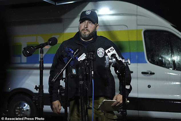 Chad Rogers, public information officer for the Pearland Police Department, provides a statement to the media following a shooting outside Cole's Antique Village and Flea Market, Sunday, Nov. 12, 2023, in Pearland, Texas, near Houston.  (Elizabeth Conley/Houston Chronicle via AP)