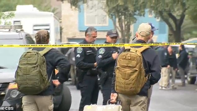 FBI agents arrive at the South Austin home where the officer was killed