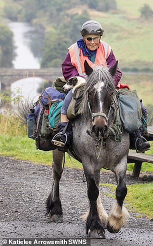 She carries everything she needs, including her tent, food, a few belongings and her Jack Russel, Dinky, stored in the saddle bag