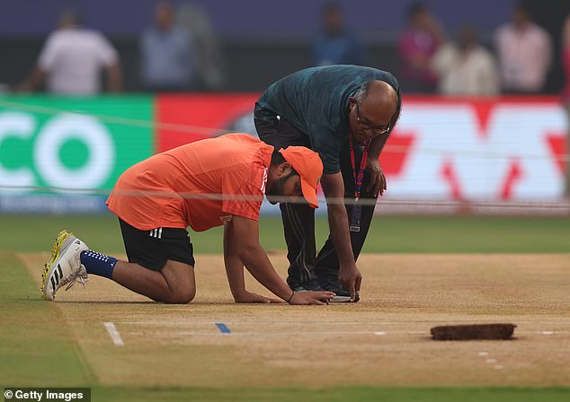 India's Rohit Sharma inspects the pitch during training on Thursday