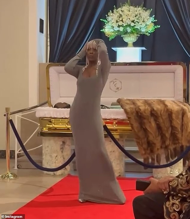 The model walked the red carpet and blew Moore a kiss before posing in front of his open casket