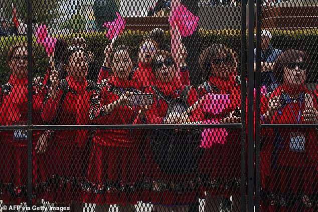 Supporters await the arrival of Chinese President Xi Jinping next to the Asia-Pacific Economic Cooperation (APEC) summit