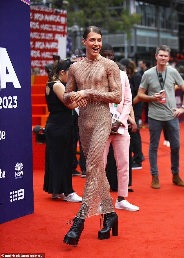 He showed off his toned and toned abs as he posed on the red carpet in the very racy ensemble and wore black boots, which did not compliment his look.