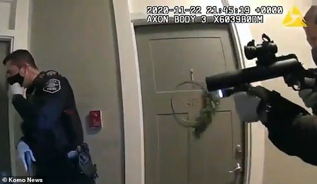 Footage shows officers shouting: 'Seattle Police, show me your hands'