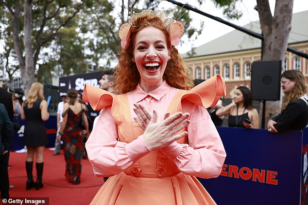 Former Yellow Wiggle Emma Watkins wore an orange dress with ruffled sleeves and a pink shirt