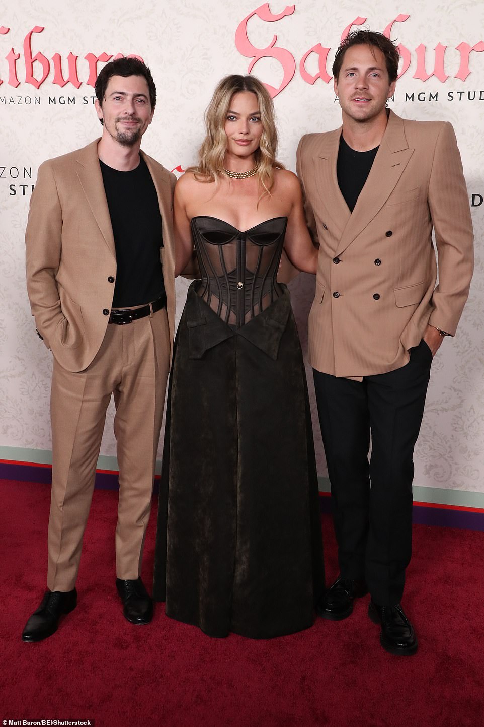 Margot and her husband Tom Ackerley (right) posed for a photo with Saltburn producer Josey McNamara