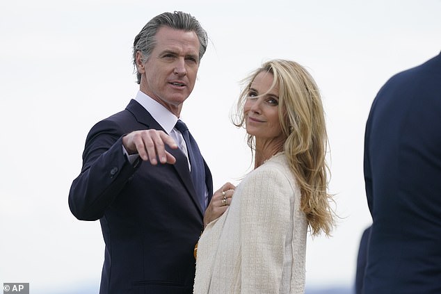 Newsom and his wife are seen on the tarmac of San Francisco airport on Tuesday