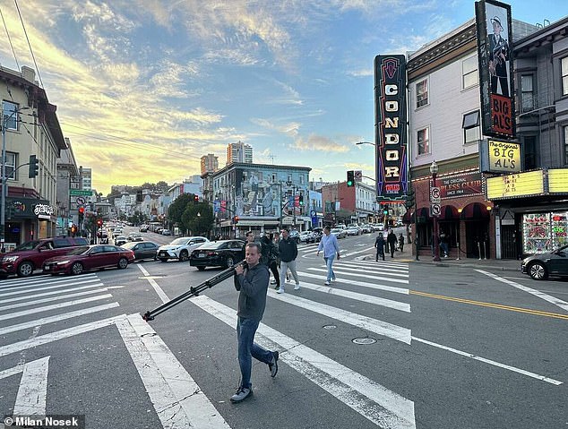 Milan Nosek, a journalist from the Czech Republic, carries a camera on Columbus Avenue in San Francisco's North Beach neighborhood.  Nosek and the team of television journalists he was with were robbed of their camera and other equipment nearby while covering the APEC summit