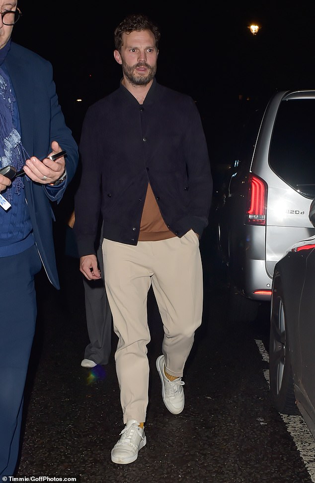 Looking good: Jamie seemed in good spirits as he headed to the car with his wife after the lavish dinner