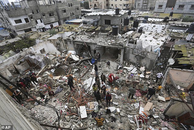 Ms Albanese, a human rights lawyer, claimed that Israel had no right to claim self-defence because Gaza is under its 'belligerent occupation' (photo: Palestinians search rubble after Israeli attacks on Rafah)