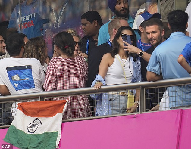 Looking good: The father of four was spotted between two onlookers who looked happy to take a photo with the star