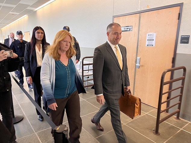 She appeared somber as she entered with her legal team