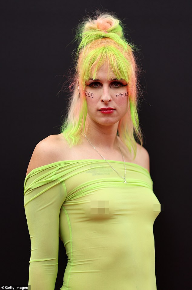 The musician turned heads by going topless under a sheer green dress that left little to the imagination