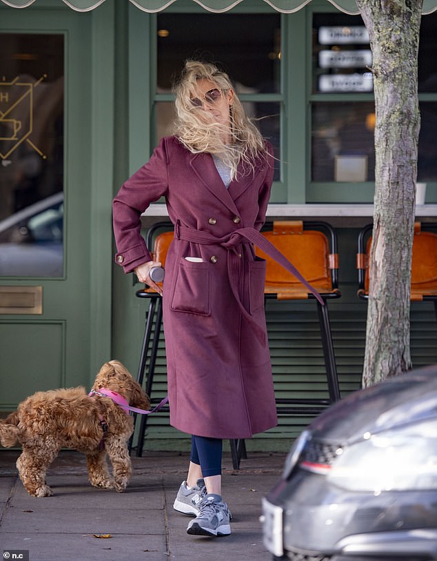 Windswept: She wore her blonde locks in loose, natural waves and added square sunglasses to the understated look