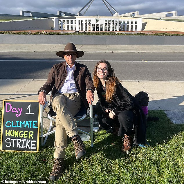 Andrews is pictured with a supporter on the first day of his hunger strike outside Parliament House in Canberra