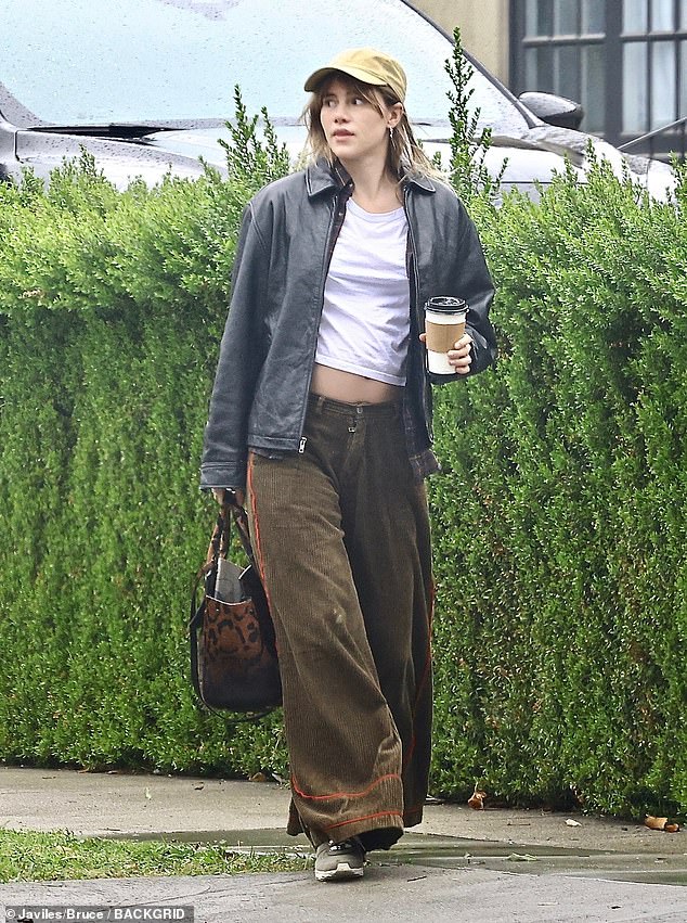 Cool girl: The singer and actress, 31, showed off her midriff in a white crop top, which she paired with brown corduroy bottoms