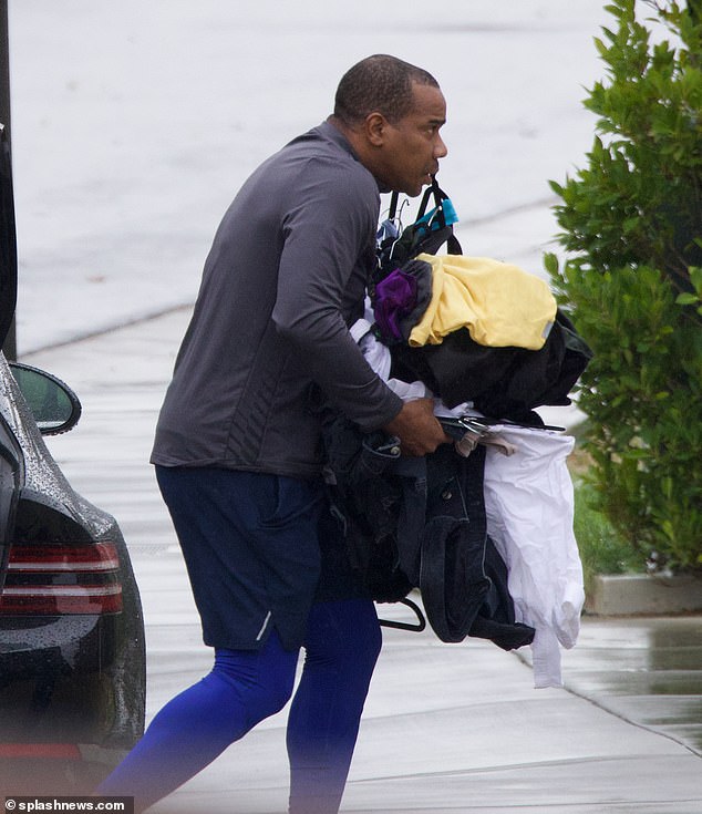 Hands full: Martin had his hands full with numerous items of clothing