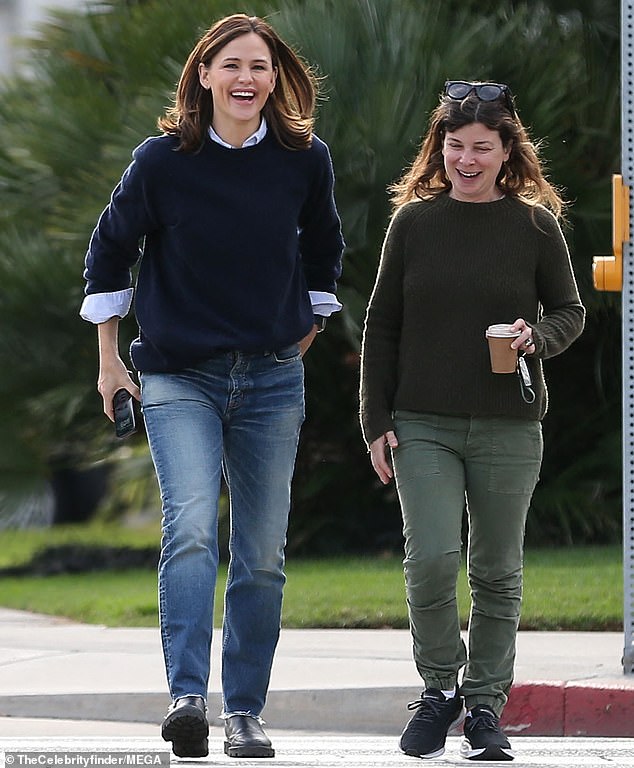 Beautiful: Her beautiful dark brown hair fell over her shoulders and matched the tone of her outerwear