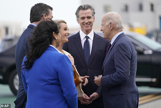 President Joe Biden greets California Governor Gavin Newsom, center, and his wife Jennifer, San Francisco London Breed and Rep. Kevin Mullin, D-Calif., front, as he arrives at San Francisco International Airport for the APEC summit.  Newsom has become a top campaign surrogate for the 80-year-old Biden