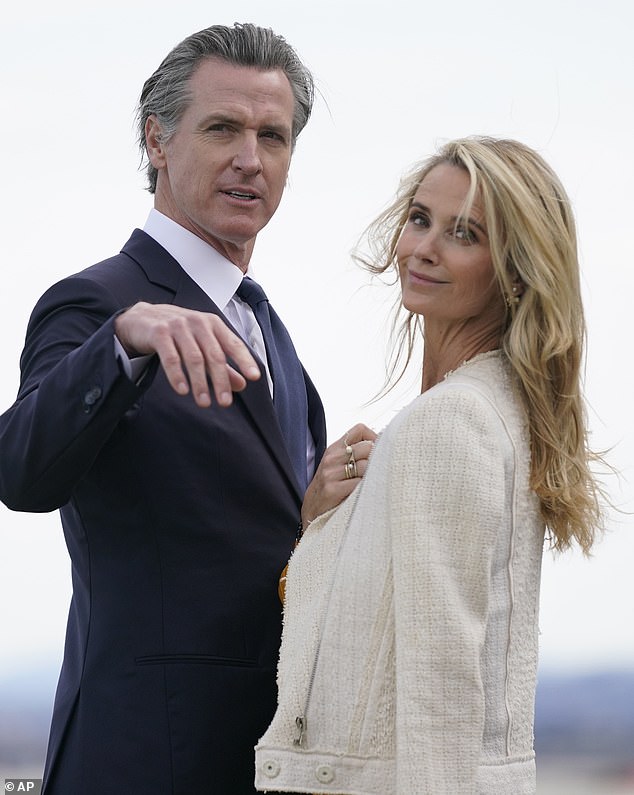 California Governor Gavin Newsom and his wife Jennifer wait to greet President Joe Biden at San Francisco International Airport.  Newsom will hold a fundraiser for Biden and Vice President Kamala Harris on Tuesday evening