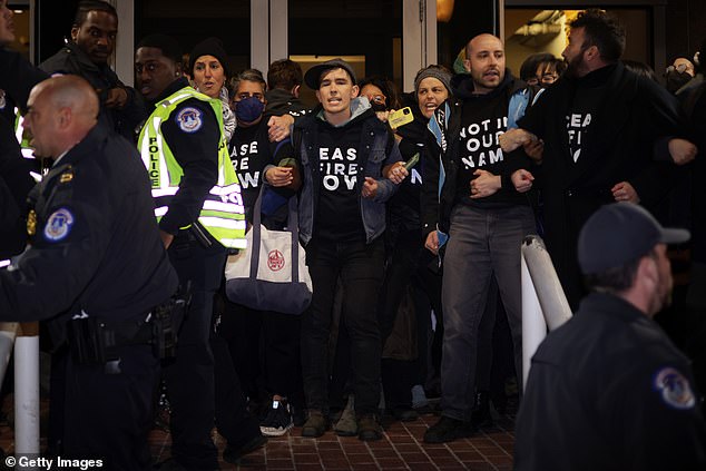 Protesters from IfNotNow and other pro-Palestinian groups wear 'Ceasefire NOW' t-shirts as they demand Israel stop fighting Hamas terrorists