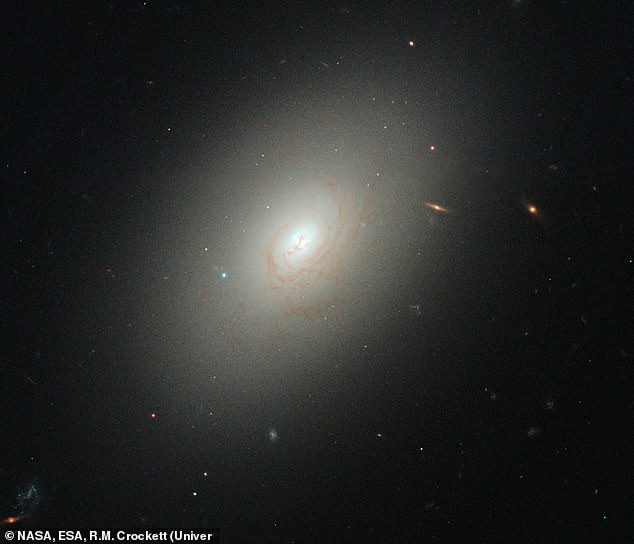 12P/Pons-Brooks suddenly brightened more than 100 times as bright as the elliptical galaxy (pictured) 600 million light-years from Earth.