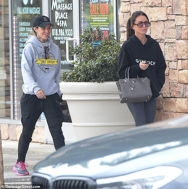 All smiles: Morgan swapped her hoodie from the French luxury brand for a gray one with a cat graphic, while she also wore black cargo pants and a baseball cap