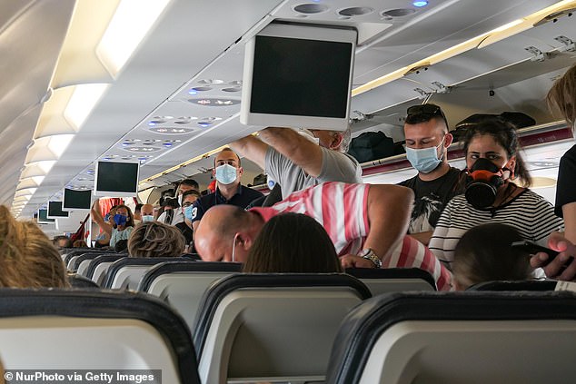 Federal prosecutors said the 29-year-old was sentenced to 3.6 months in prison in connection with her actions — plus three years of supervised probation.  Pictured: A group of passengers wearing face masks