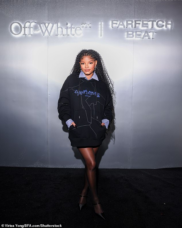 Effortless chic: The singer looked effortlessly chic in an oversized hoodie, worn as a dress and layered over a pinstripe button-down for an elevated touch for the party at Delilah in Los Angeles